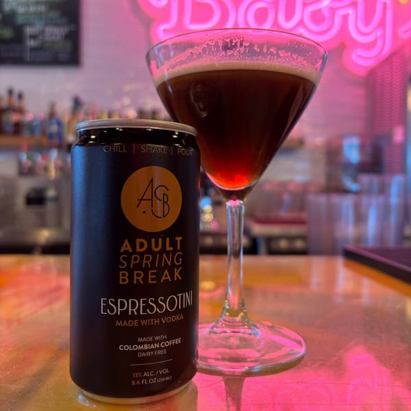 An "Adult Spring Break Espressotini" can next to a martini glass filled with a dark beverage.